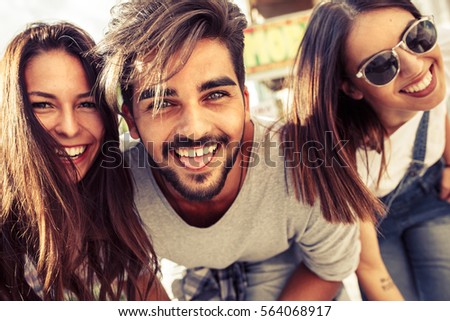 Group of happy young friends having fun on city street.Sunset.Close up image.