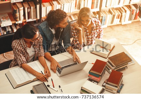 Group of female students study in the school library.Learning and preparing for university exam.