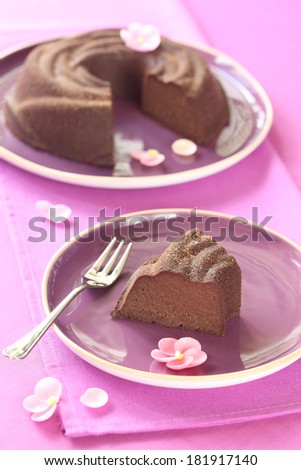 Chocolate Pudding Cake served on purple plates, on a purple background.