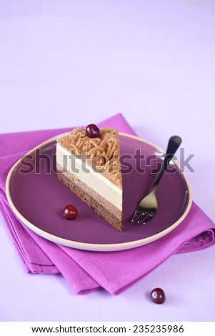 Piece of Chestnut Multi-Layered Mousse Cake on a bright purple plate and napkin, on a light purple background.