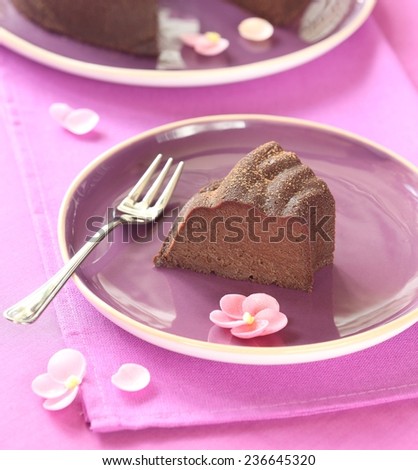 Baked Chocolate Pudding Cake served on purple plates, on a purple background.