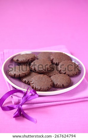 Vegan Chocolate Raspberry Cookies in a purple plate on a purple background.