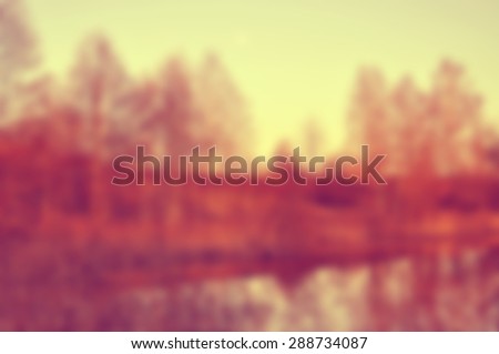 Autumn sunset on the lake. Blur natural background.