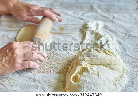Kitchen, cooking pies with dough on the table, close up