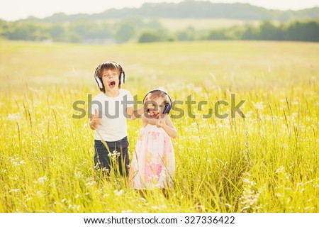Happy kids listen to music on nature