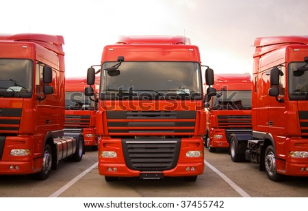 Red trucks stand in line front view