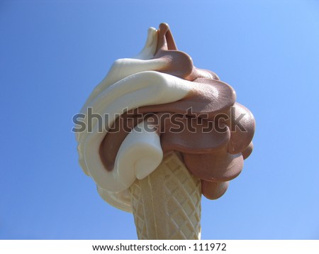 An ice-cream cone with chocolate and vanilla ice.