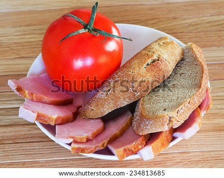 bread, meat and tomato on white plate