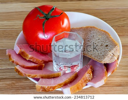 bread, meat, tomatoes and a glass of vodka
