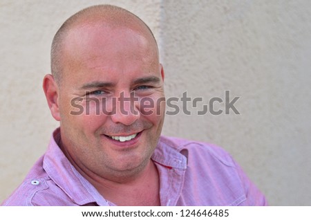 Happy middle aged bald man smiling