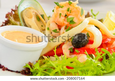 Seafood salad with prawns, oysters and squid served with a side