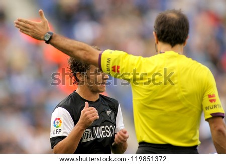BARCELONA - OCT, 27: Sebastian Fernandez of Malaga CF speaking with the referee during a Spanish League match between Espanyol and Malaga at the Estadi Cornella on October 27, 2012 in Barcelona, Spain