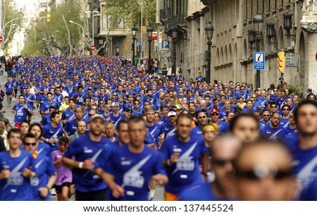BARCELONA - APRIL, 21: Barcelona street crowded of athletes running during Bombers Race in Barcelona April 21, 2013 in Barcelona, Spain