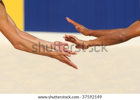Hands of a beach volley players celebrating a point
