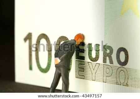 A one hundred euro bill with a figure of a man leaning on it and worrying.