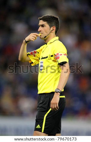 BARCELONA - MAY 21: Referee Undiano Mallenco blowing whistle during a Spanish League match between RCD Espanyol and Sevilla, FC at the Estadi Cornella on May 21, 2011 in Barcelona, Spain
