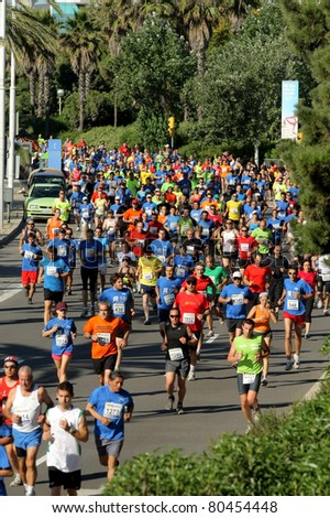BARCELONA - JUNE, 26: Runners on the popular race of the Olympic Village that takes place through the streets of Barcelona on June 26, 2011 in Barcelona, Spain
