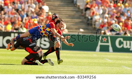 BARCELONA - APRIL 9: Florian Cazenave of Perpignan is tackled during the European Cup quarter-final match USAP Perpignan against RC Toulon at the Olympic Stadium on April 9, 2011 in Barcelona, Spain
