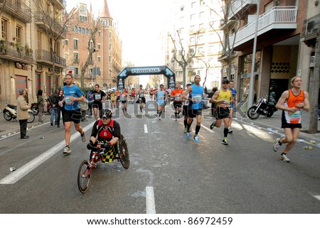 BARCELONA - MARCH 3: Athlete with mobility disabilities participate in Barcelona street crowded of athletes during Barcelona Marathon in Barcelona on March 3, 2011 in Barcelona, Spain