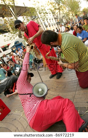 BARCELONA - SEPT 24: Musicians of Always Drinking Marching Band in full swing performing his show at Las Ramblas during a Festival City on September 24, 2004 in Barcelona, Spain