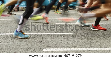 Runners feet on the road in blur motion during a long distance running event