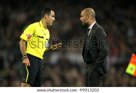BARCELONA - MARCH 3: Referee Velasco Carballo talks with Pep Guardiola of Barcelona during the Spanish league match against Sporting Gijon at the Camp Nou stadium on March 3, 2012 in Barcelona, Spain