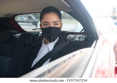 Business woman on her way to work in car.