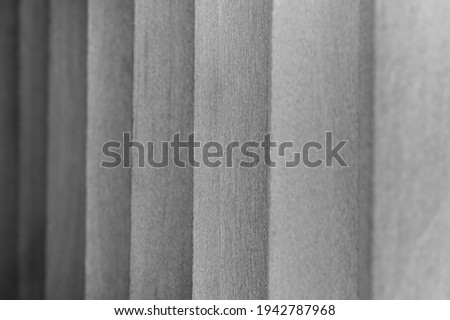 A grayscale shot of wooden planks under the lights with a blurry background