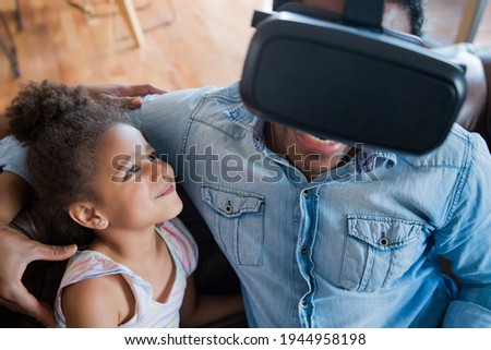 Father and daughter playing video games.