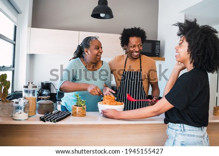 Portrait of family cook together at home.