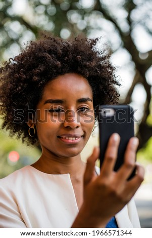 Afro business woman having a video call on mobile phone.
