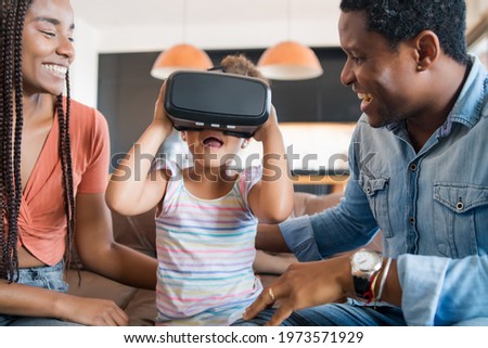 Family playing video games with VR glasses.