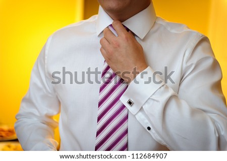 Groom fixing tie