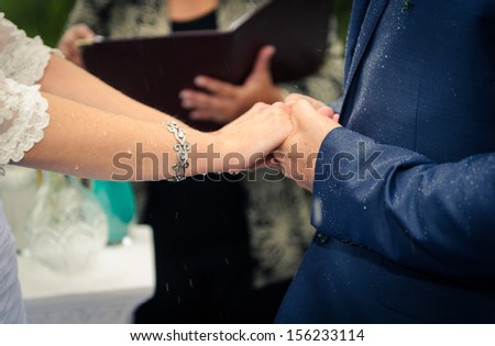 Wedding hands under the rain