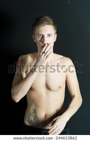 Naked handsome man covering his mouth, speak no evil concept