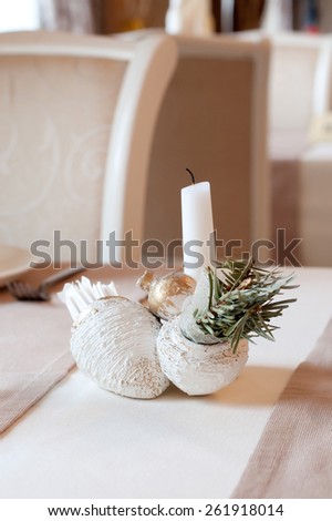 Still life with gold garnet and candle. Decor in restaurant