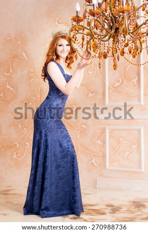 Queen, royal person with crown, red hair and violet, blue dress. Chandelier