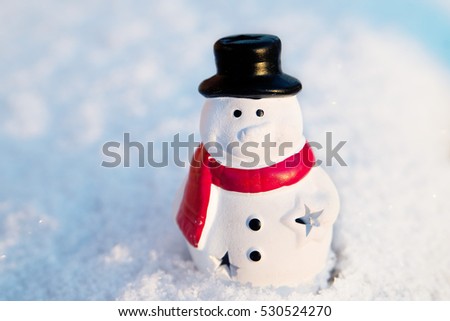 Snow man, snowman toy on snow background