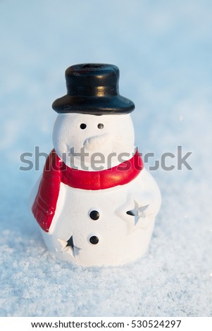 Snow man, snowman toy on snow background