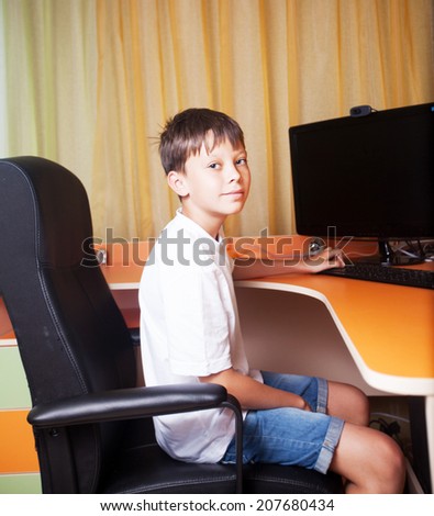 the boy at the computer table, home