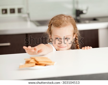 little girl reaching for food