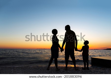 Family Silhouette. Sunset at sea.