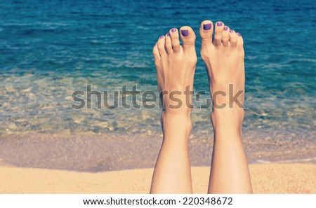 Relaxing on the beach with legs up. Sexy legs. Retro look