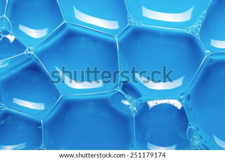 Blue liquid with bubbles and reflections