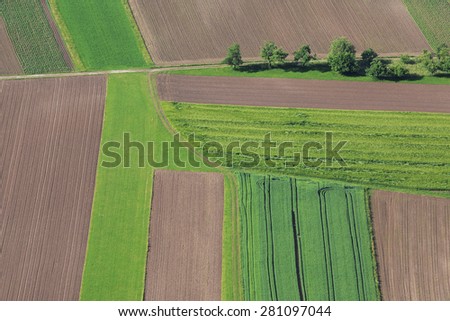 Cultivated field from above. Aerial view of meadows and cultivated fields. Birds view. Arable land.