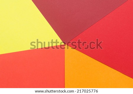warm-colored construction paper sheets arranged to form a star