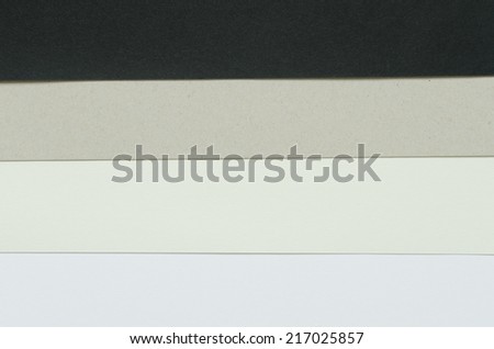 construction paper sheets arranged horizontally from black to white