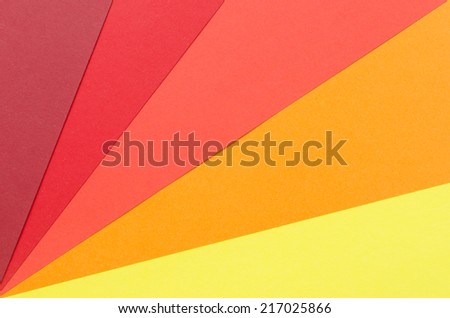 warm-colored construction paper sheets arranged diagonally
