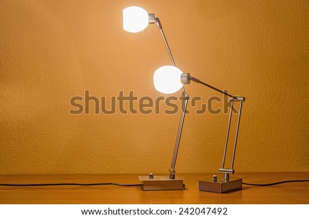 two lit modern table lamps interacting with each other