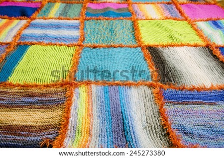 overview of a colorful handmade blanket